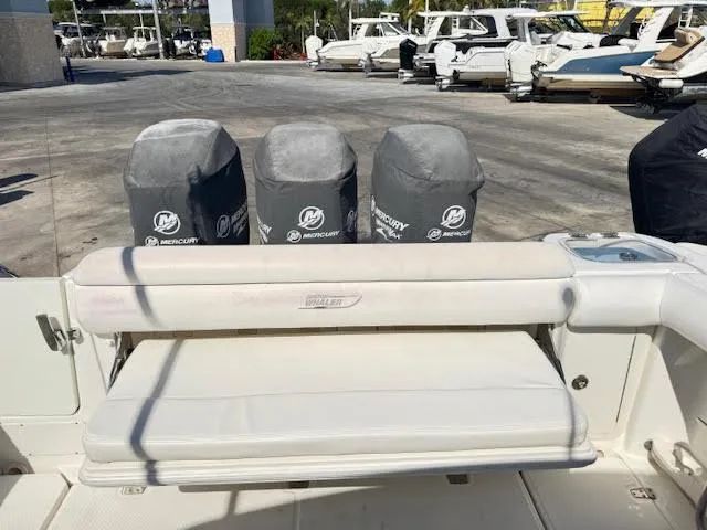 Slide: The Image of Boston Whaler 350 Outrage 2016 with Mercury engine covers, docked at a marina. - 23