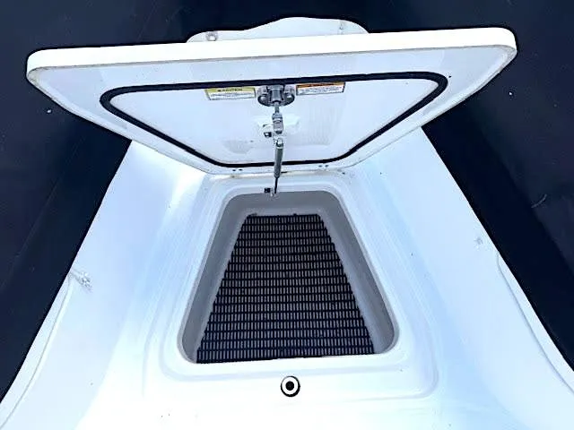 Slide: The Image of 2016 Boston Whaler 350 Outrage storage compartment with open hatch. - 25