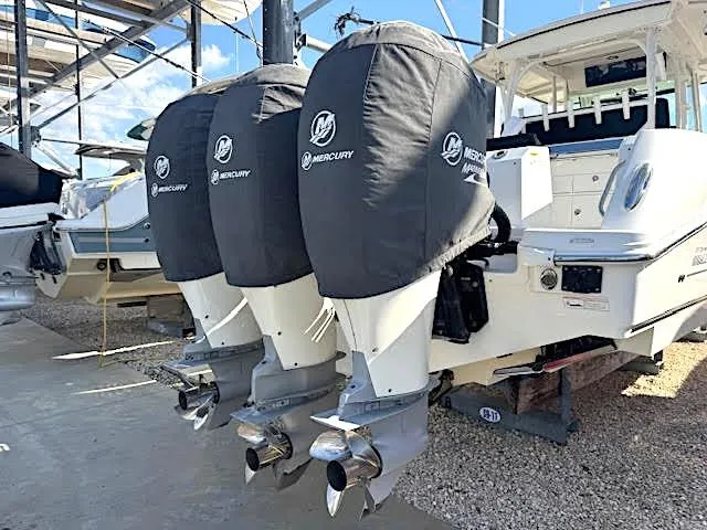 Slide: The Image of 2016 Boston Whaler 350 Outrage with triple Mercury engines, docked and covered. - 6
