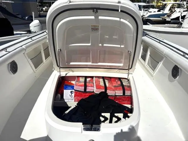 Slide: The Image of 2016 Boston Whaler 350 Outrage storage compartment with life jackets and supplies. - 9