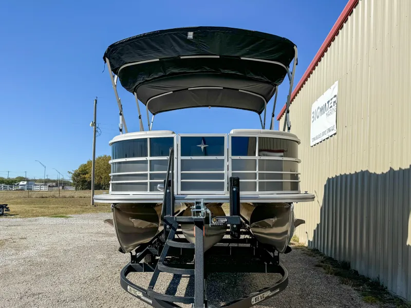 Slide: The Image of 2024 Berkshire 24RFXLE pontoon boat on trailer, parked outdoors near a building. - 3