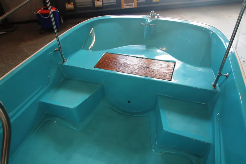 Slide: The Image of 1970 Boston Whaler Mauntak boat interior with blue seating and wooden accents. - 9