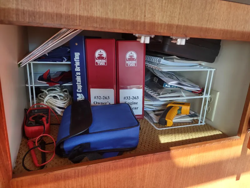 Slide: The Image of Storage compartment with Nordic Tug manuals, ropes, and equipment on a 2006 Nordic Tug 32. - 25