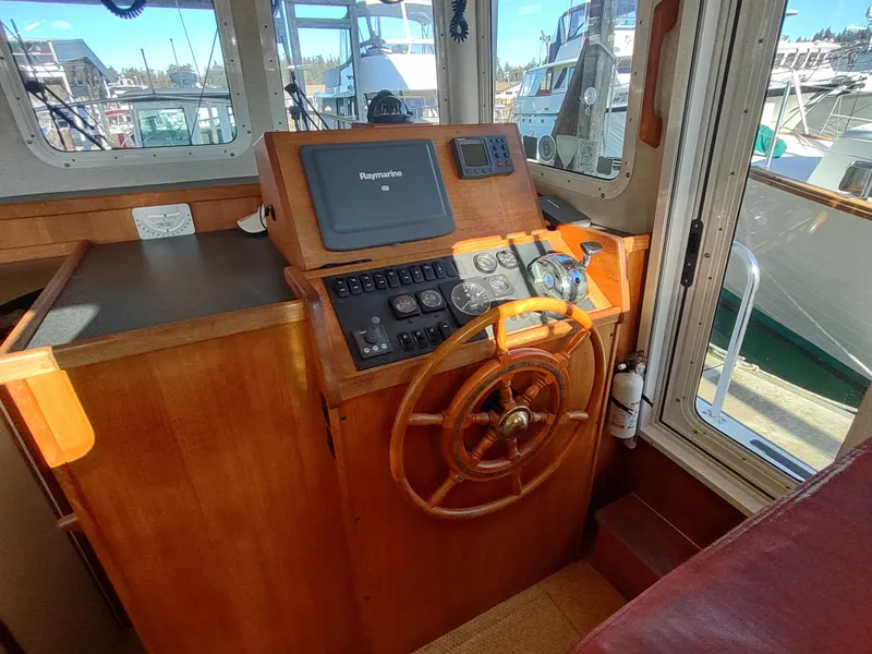 Slide: The Image of 2006 Nordic Tug 32 helm with wooden wheel and navigation equipment. - 31