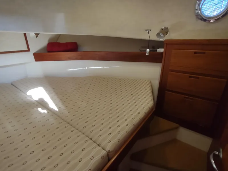 Slide: The Image of Cozy cabin interior of 2006 Nordic Tug 32 with bed and wooden storage. - 42
