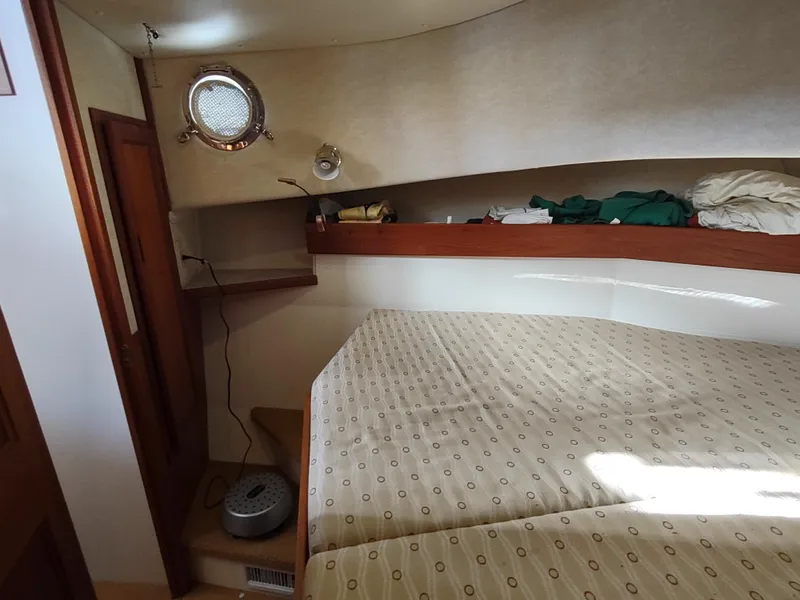 Slide: The Image of Cozy cabin interior of 2006 Nordic Tug 32 with bed and porthole. - 43