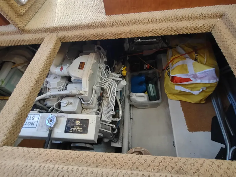 Slide: The Image of Engine compartment of a 2006 Nordic Tug 32, showing engine and storage area. - 47