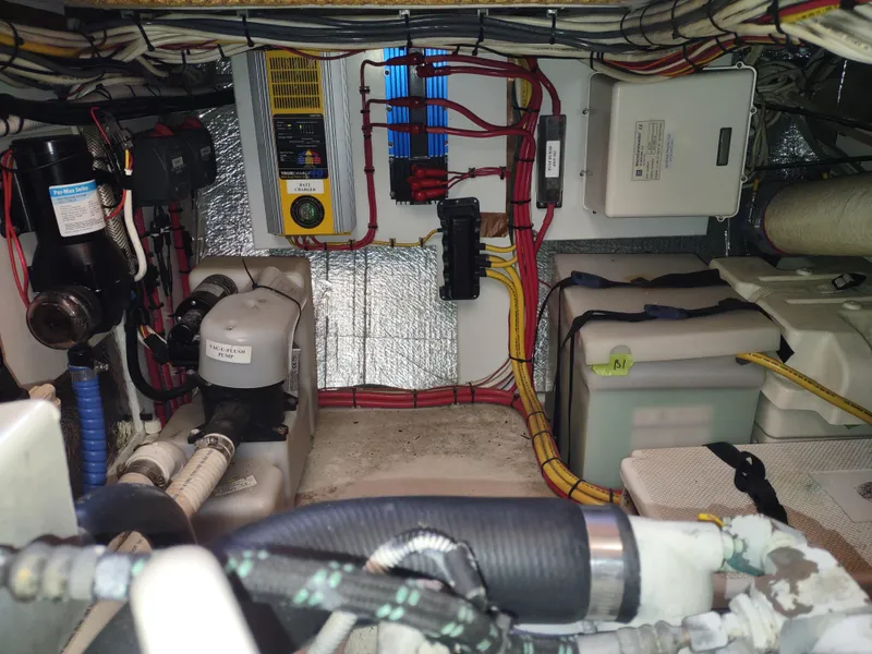 Slide: The Image of Engine room of a 2006 Nordic Tug 32, showcasing wiring and mechanical components. - 48