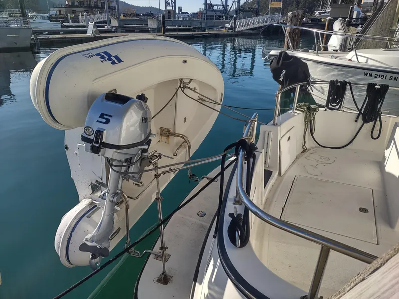 Slide: The Image of 2006 Nordic Tug 32 with dinghy and outboard motor at marina dock. - 6