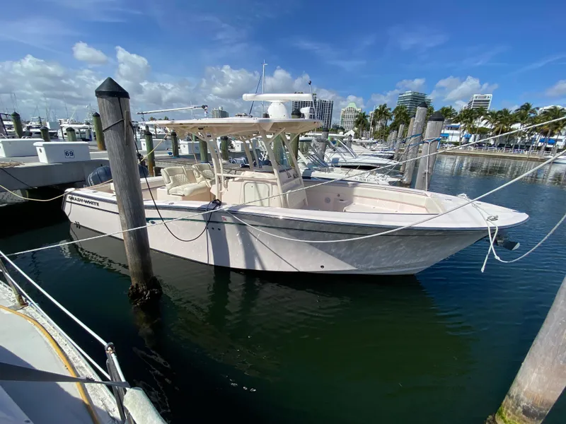 The Image of 2016 Grady-White Canyon 306 boat docked in marina under clear blue sky. - 1