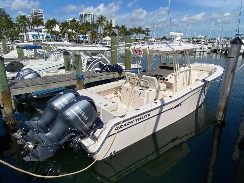 Slide: The Image of 2016 Grady-White Canyon 306 boat docked in marina with Yamaha engines. - 4