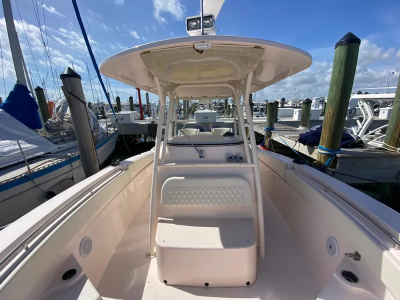 Slide: The Image of 2016 Grady-White Canyon 306 boat docked at marina under clear blue sky. - 6