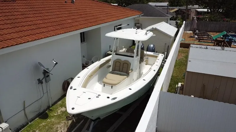 Slide: The Image of 2017 Sea Hunt Gamefish 27 with Coffin Box parked beside a house. - 3