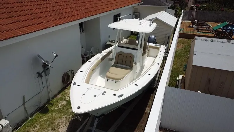 Slide: The Image of 2017 Sea Hunt Gamefish 27 with Coffin Box, parked beside a house. - 4