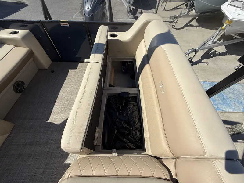 Slide: The Image of Veranda Vista View Series 2025 boat interior with beige seating and storage compartment. - 10