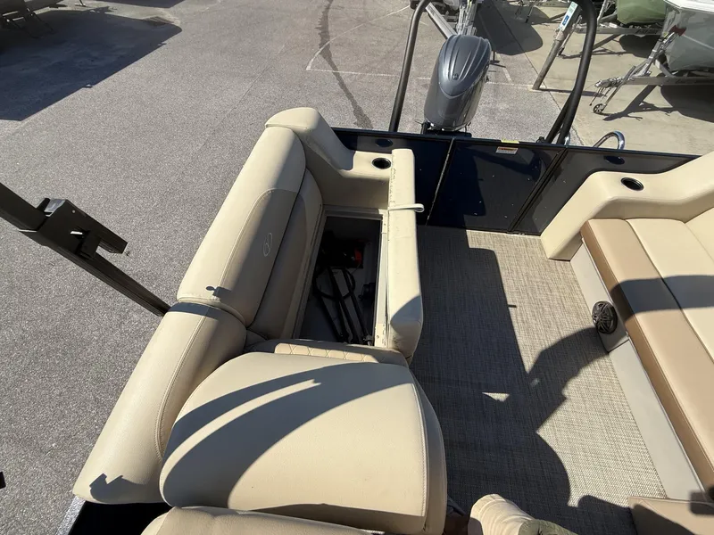 Slide: The Image of Veranda Vista View Series 2025 boat interior with beige seating and storage compartment. - 12