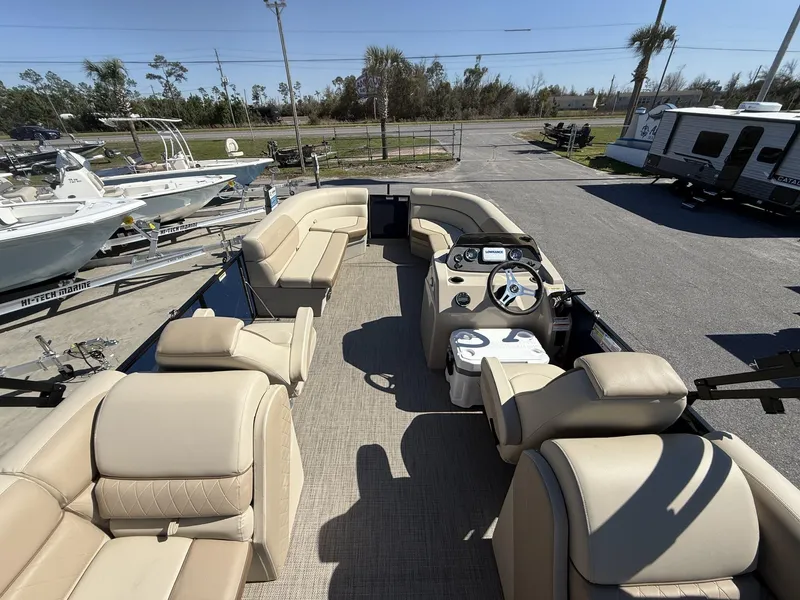 Slide: The Image of 2025 Veranda Vista View Series boat interior with beige seating and modern dashboard. - 13