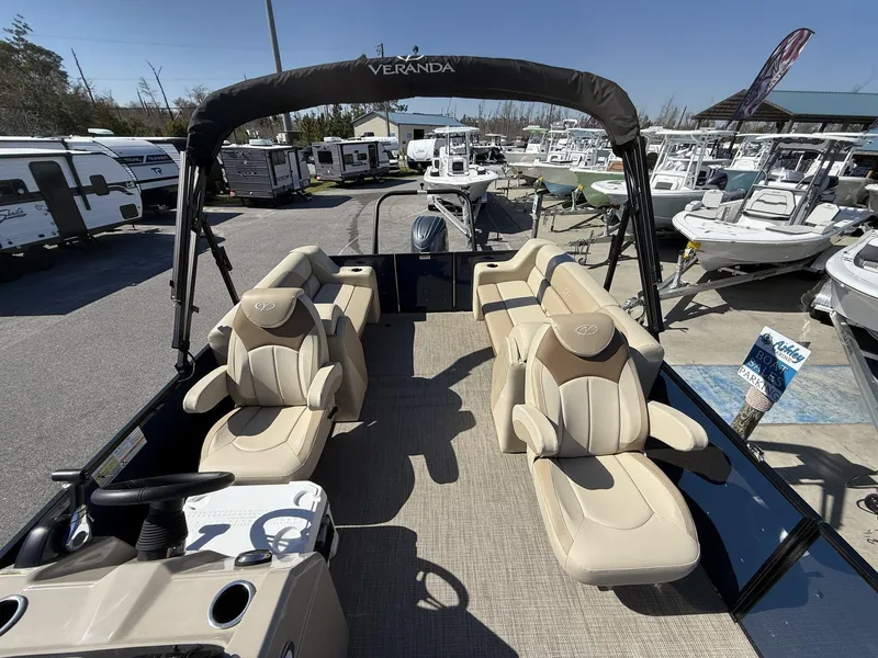 Slide: The Image of 2025 Veranda Vista View Series boat with luxurious seating at a marina. - 14