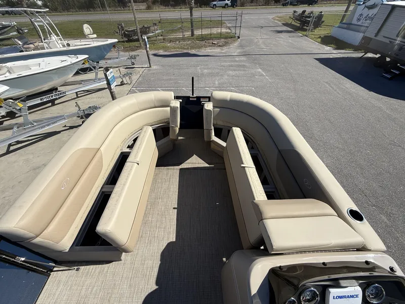 Slide: The Image of 2025 Veranda Vista View Series boat interior with beige seating and open storage compartments. - 7