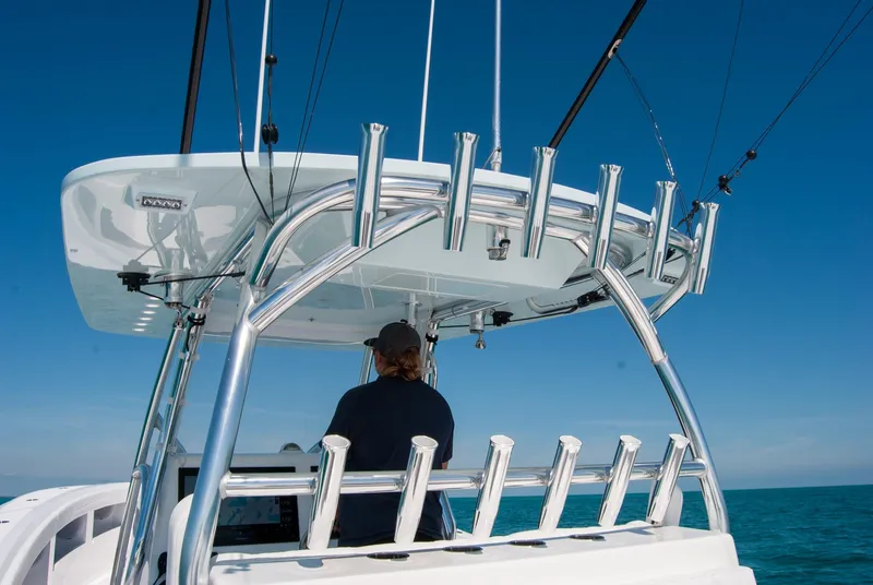 Slide: The Image of 2025 Front Runner 36 Center Console boat with fishing rod holders, navigating on open water. - 10