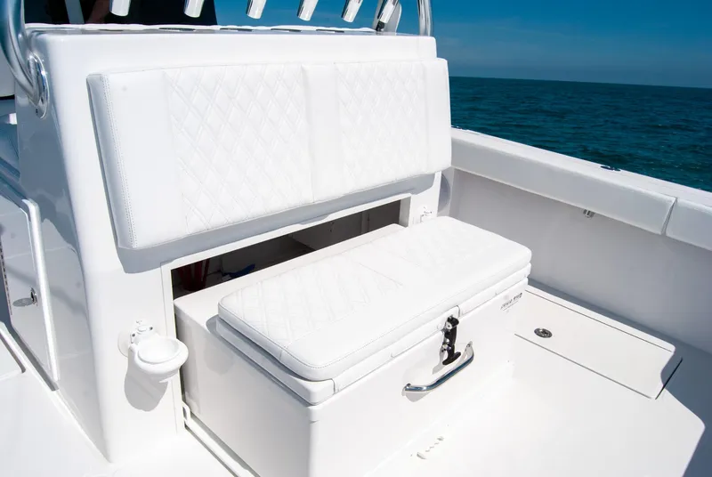 Slide: The Image of 2025 Front Runner 36 Center Console boat with white cushioned seating and ocean backdrop. - 11