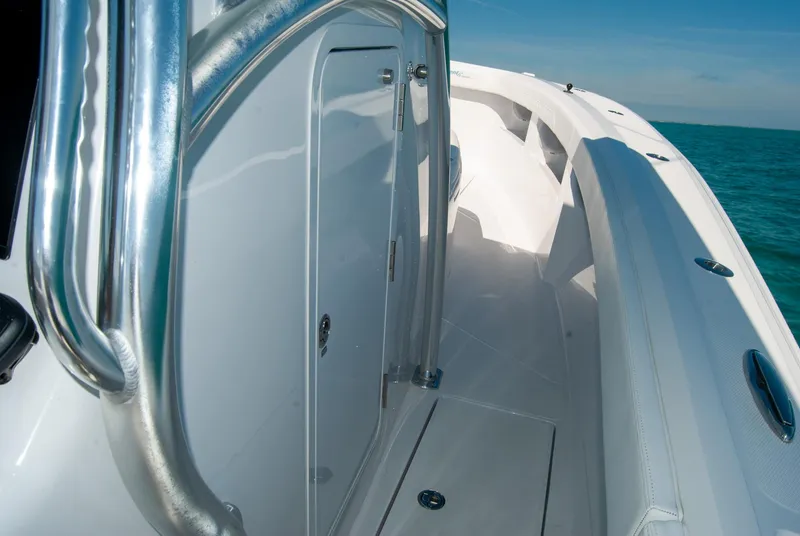 Slide: The Image of 2025 Front Runner 36 Center Console boat, sleek design, stainless steel railings, ocean backdrop. - 13