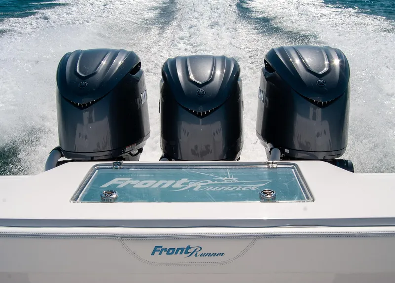 Slide: The Image of 2025 Front Runner 36 Center Console with triple outboard engines on the water. - 2
