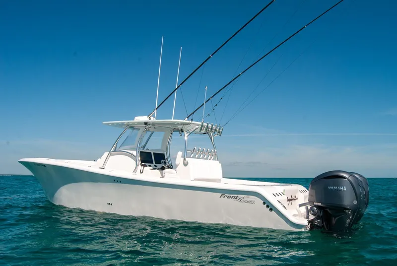 Slide: The Image of 2025 Front Runner 36 Center Console boat on open water, equipped with fishing rods. - 21