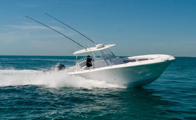 Slide: The Image of 2025 Front Runner 36 Center Console boat speeding on open water. - 31