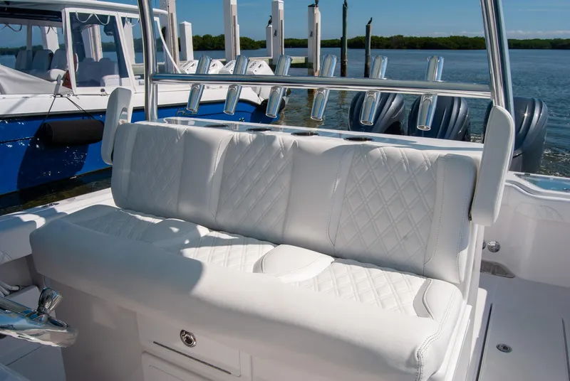 Slide: The Image of 2025 Front Runner 36 Center Console with white cushioned seating and rod holders. - 5