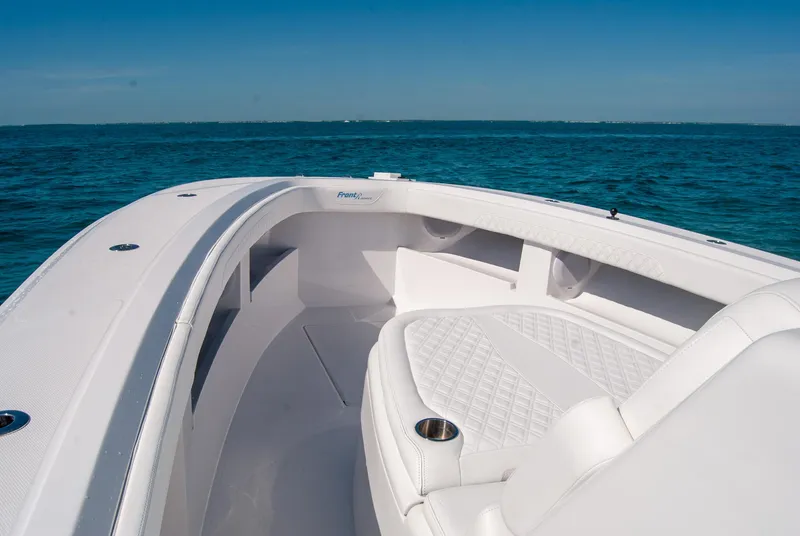 Slide: The Image of 2025 Front Runner 36 Center Console boat on open water, featuring sleek white seating. - 6
