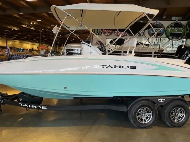 Slide: The Image of 2025 Tahoe 2150 CC boat with canopy on trailer in showroom. - 0