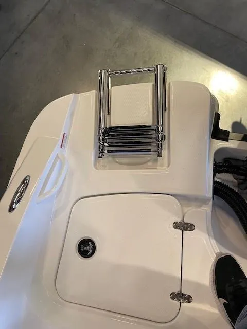 Slide: The Image of 2025 Tahoe 2150 CC boat with folded stainless steel ladder on deck. - 14