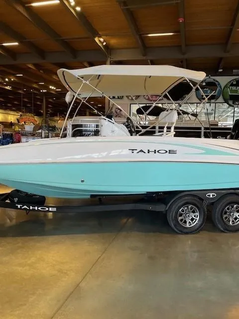 Slide: The Image of 2025 Tahoe 2150 CC boat with canopy on display in showroom. - 3