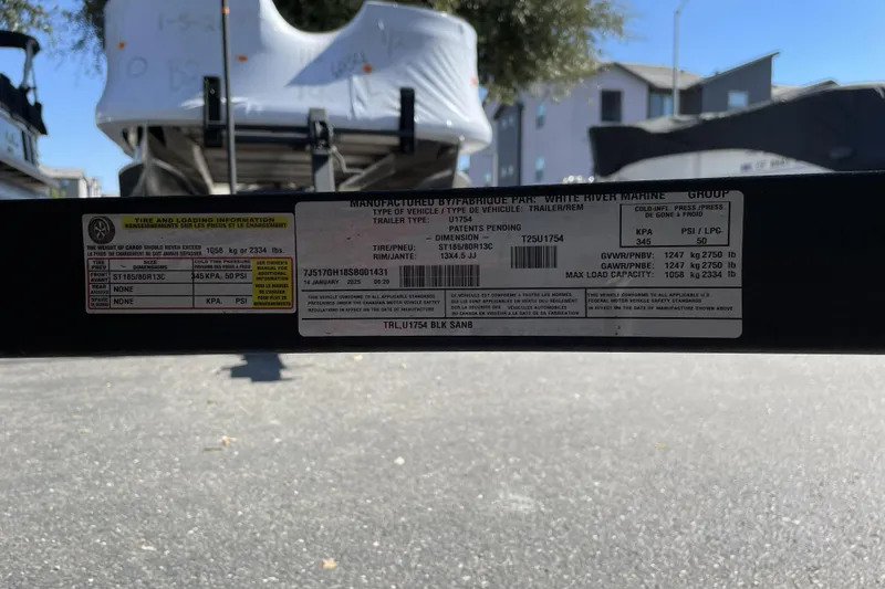 Slide: The Image of 2025 Tracker Grizzly 1754 Jon trailer label with specifications and load information. - 27