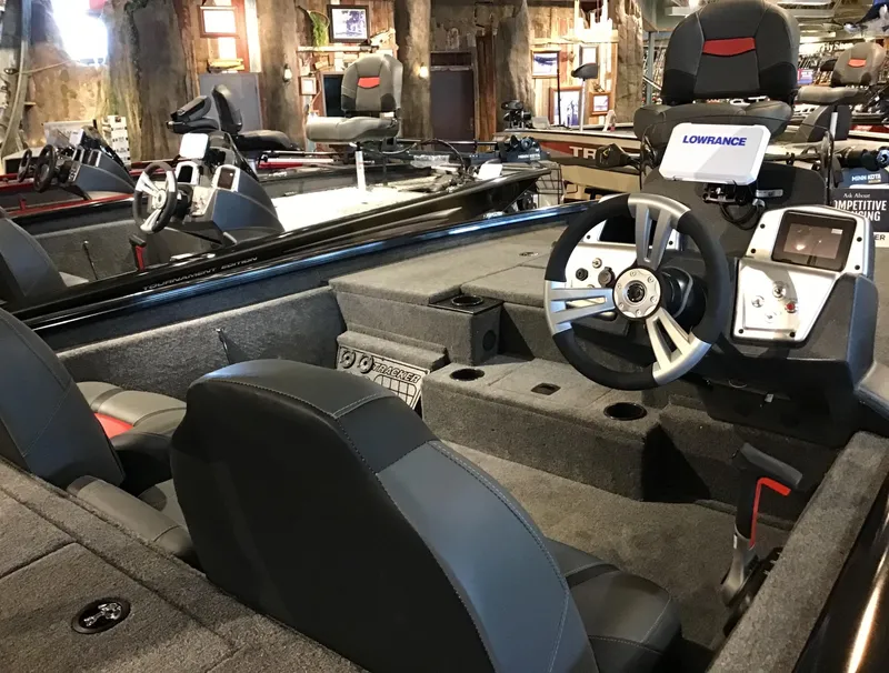 Slide: The Image of 2025 Tracker Pro Team 195 Tournament Edition boat interior with steering wheel and Lowrance electronics. - 2
