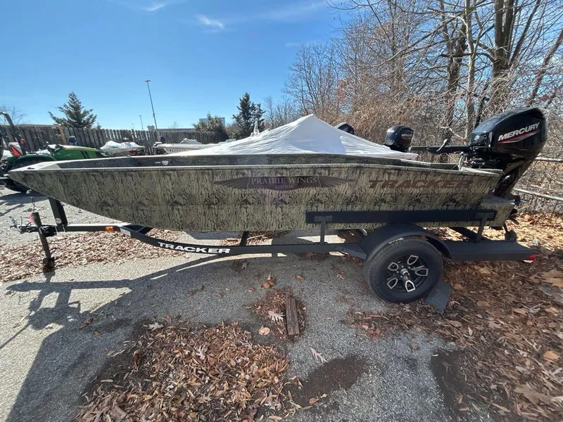 Slide: The Image of 2025 Tracker Grizzly 1650 T Prairie Wings Edition boat on trailer, outdoors. - 2