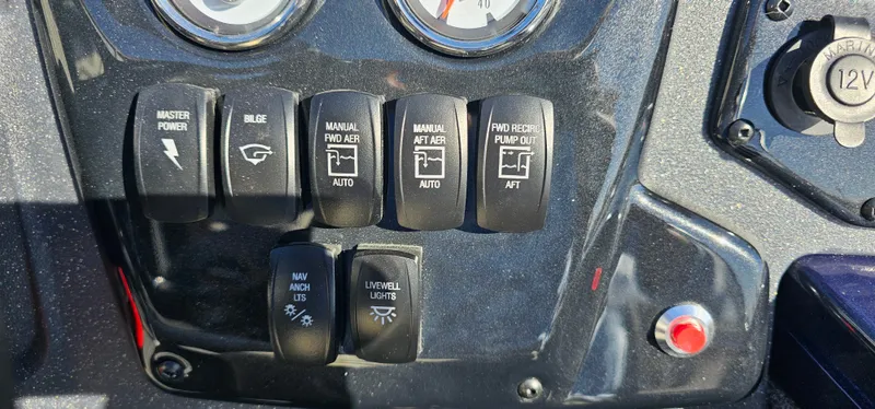 Slide: The Image of Control panel of 2025 Tracker Targa V-19 WT boat with various switches and gauges. - 10