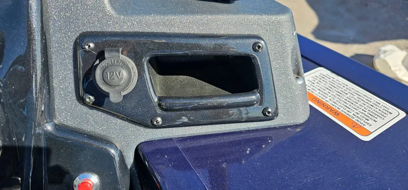 Slide: The Image of 2025 Tracker Targa V-19 WT dashboard with 12V socket and warning label. - 11