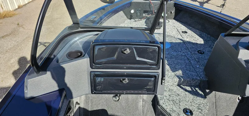 Slide: The Image of 2025 Tracker Targa V-19 WT boat interior with storage compartments and carpeted flooring. - 13