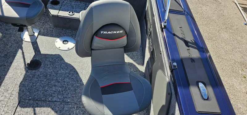 Slide: The Image of 2025 Tracker Targa V-19 WT boat interior with gray seating and carpeted flooring. - 14
