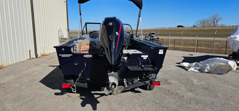Slide: The Image of 2025 Tracker Targa V-19 WT boat with outboard motor, parked outdoors. - 3