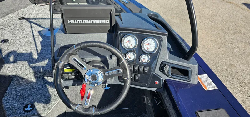 Slide: The Image of 2025 Tracker Targa V-19 WT boat dashboard with steering wheel and Humminbird electronics. - 6