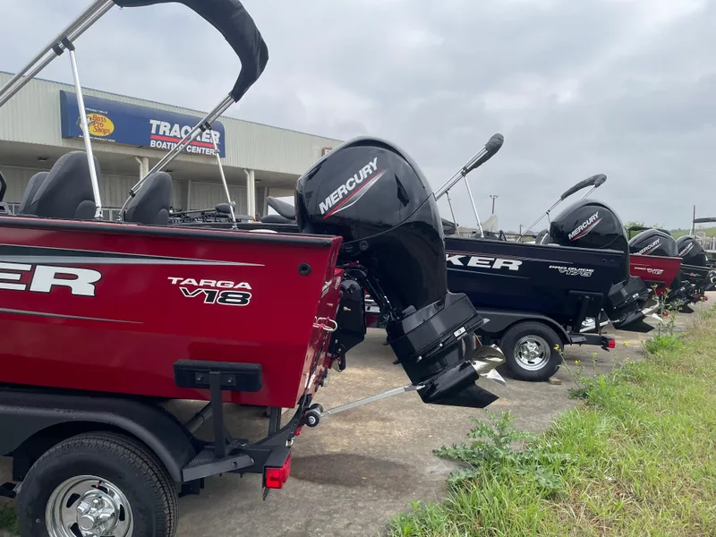 Slide: The Image of 2025 Tracker Targa V-18 Combo boats lined up at dealership, featuring Mercury engines. - 4