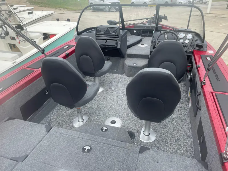 Slide: The Image of 2025 Tracker Targa V-18 Combo boat interior with four seats and dashboard view. - 6