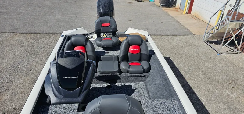 Slide: The Image of 2025 Tracker Pro Team 175 boat interior with black and red seating. - 5