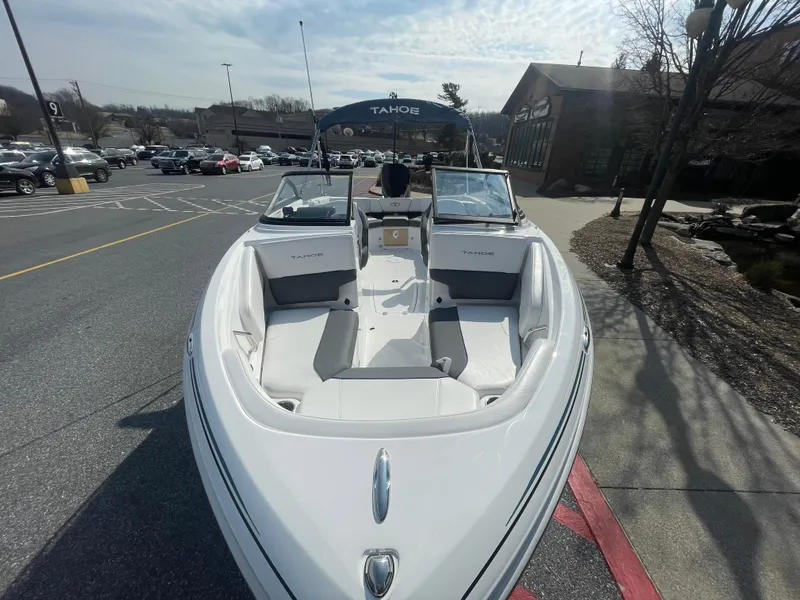 Slide: The Image of 2024 Tahoe 210 S boat parked outdoors on a sunny day. - 3