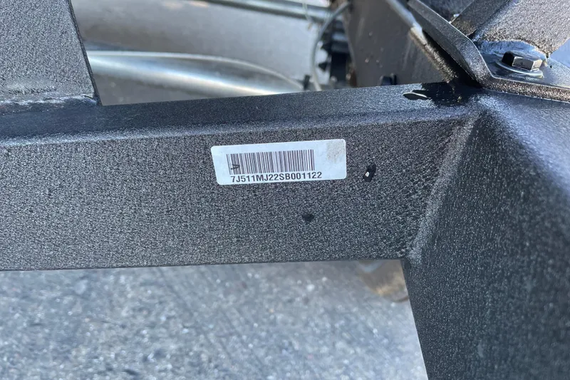 Slide: The Image of 2025 Tracker Pro Guide V-175 Combo trailer frame with visible serial number label. - 71