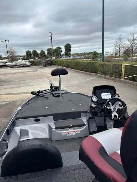 Slide: The Image of 2025 Nitro Z17 boat interior with steering wheel and seating, parked outdoors under cloudy skies. - 3