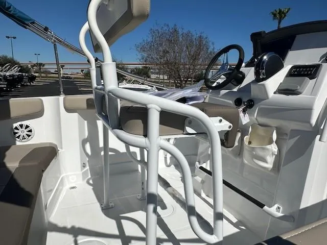 Slide: The Image of 2025 Tahoe 2150 CC boat interior with steering console and seating. - 3